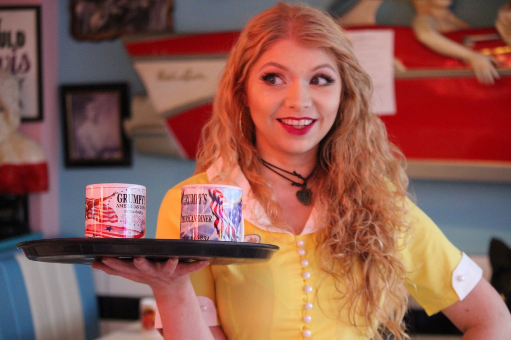 Charlie Bond as Emily - carrying a tray in a 50s diner